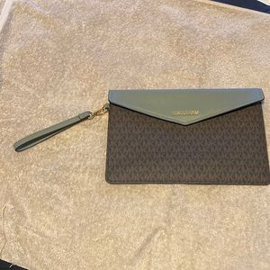 New without tags. Michael Kors Envelope Clutch brown and olive in color.